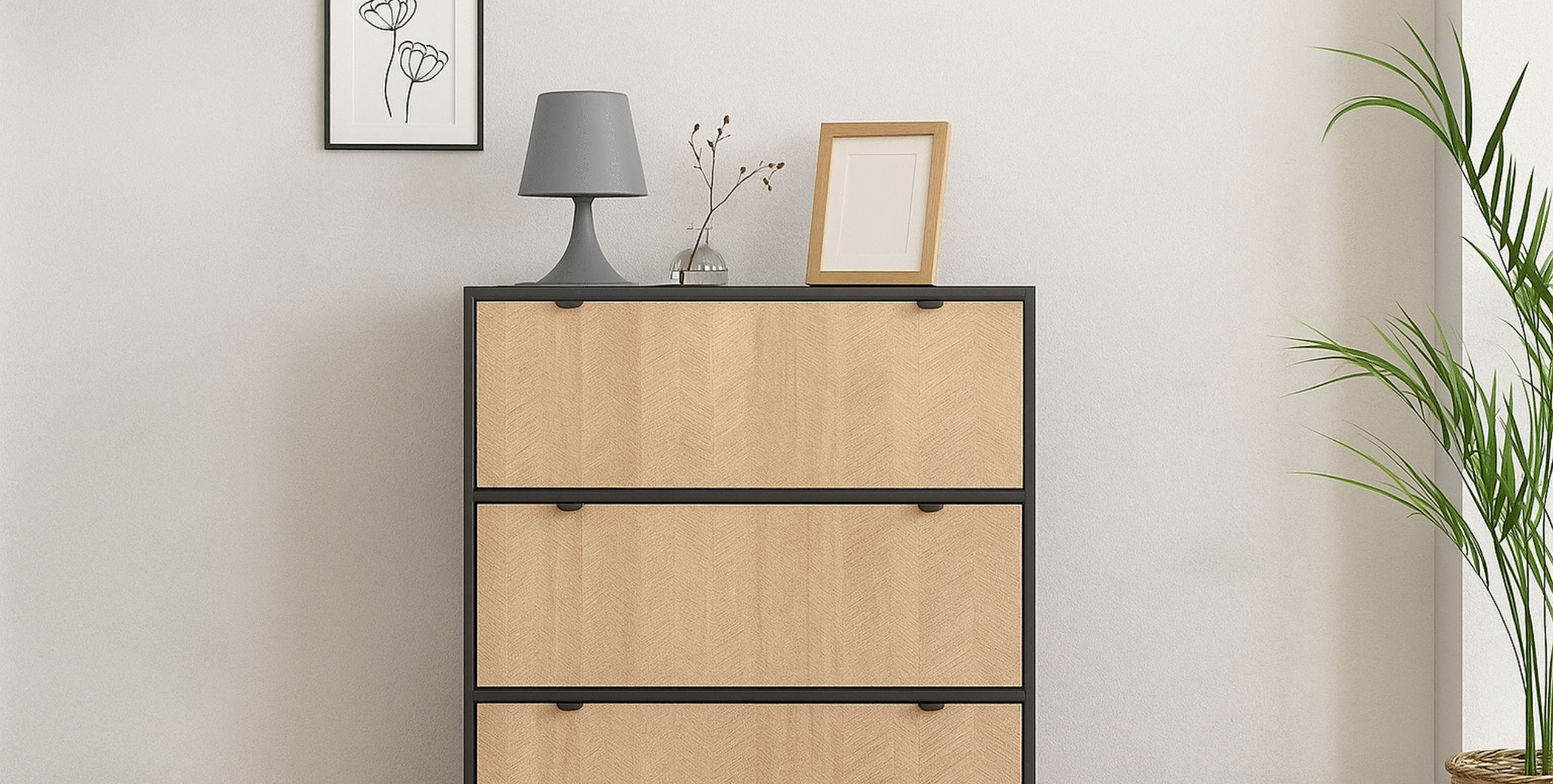 Komoda z trzema szufladami czarnym korpusem, czarnymi uchwytami z detalem jodełki